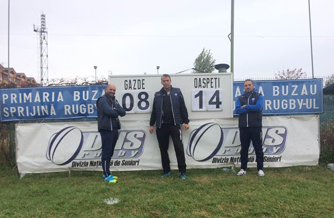 Antrenorii echipei Tomitanii Constanța, Cristian Cojocaru și Radu-Nicolae Mocanu, și managerul Răzvan Bota s-au fotografiat lângă tabela de scor a terenului de rugby din Buzău