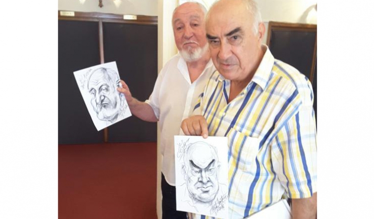 Actorul Lucian Iancu și scriitorul Ion Coja, membru al juriului, ținând în mână portretele realizate de caricaturistul și graficianul Leonte Năstase